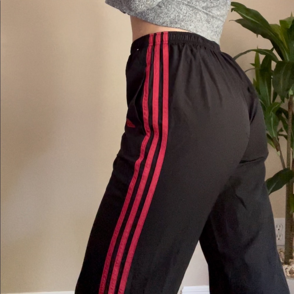 Black and red adidas track pants